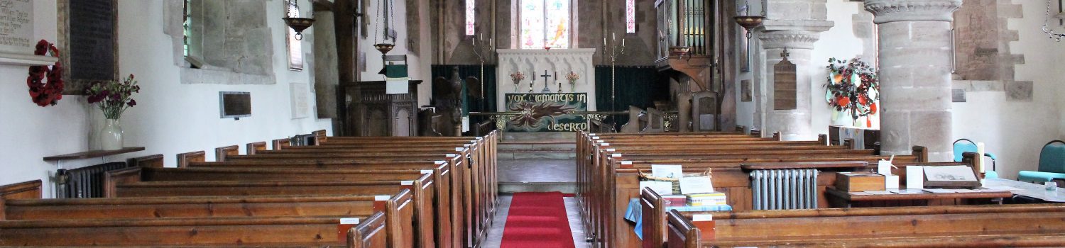 The aisle in Upton Bishop church with a red carpet and the altar