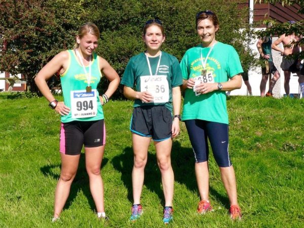 Three women dressed in running gear