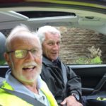 Two smiling men in a car