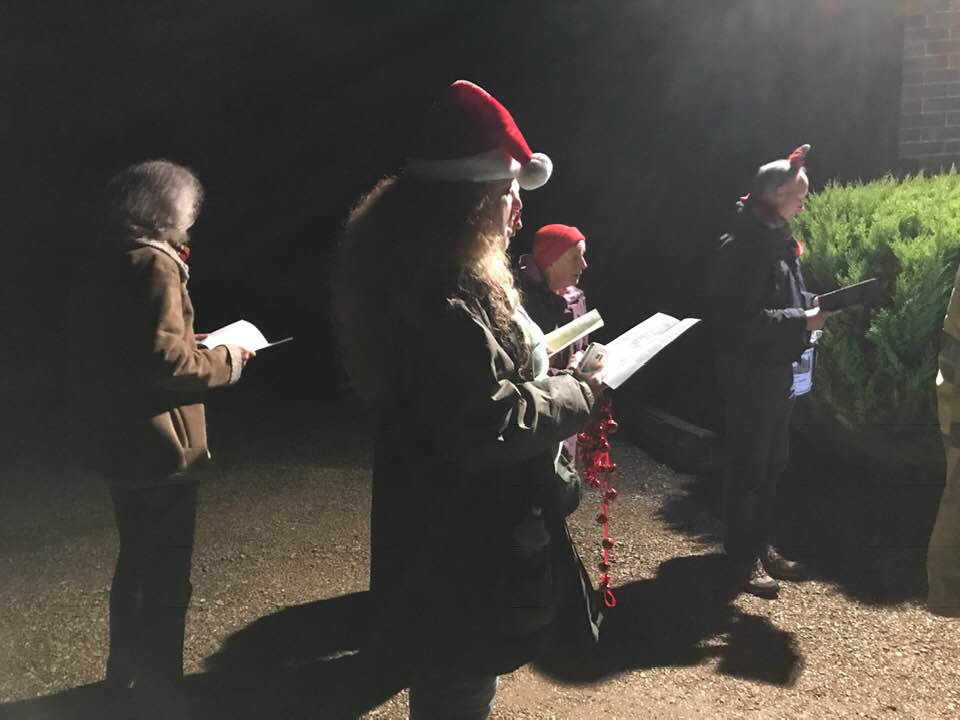 A group of carol singers in the dark