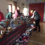 People looking at bric a brac on a table