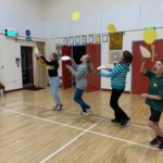 Children tossing pancakes in the village hall