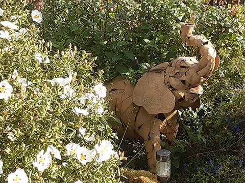 Sculpture of an elephant and white flowers