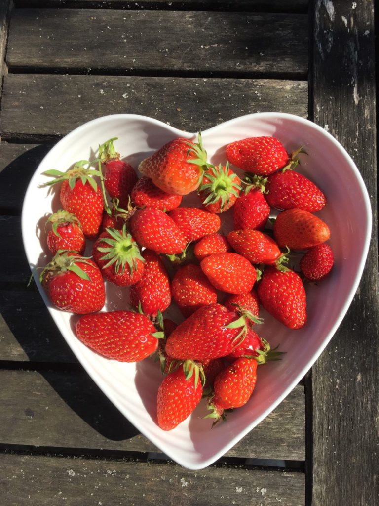 Fresh strawberries in a heart shaped bowl