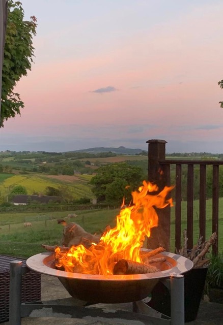 View of May Hill with a fire pit in the foreground