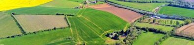 Aerial view of the village showing houses surrounded by green fields