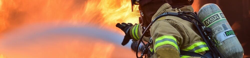 Fireman hosing flames