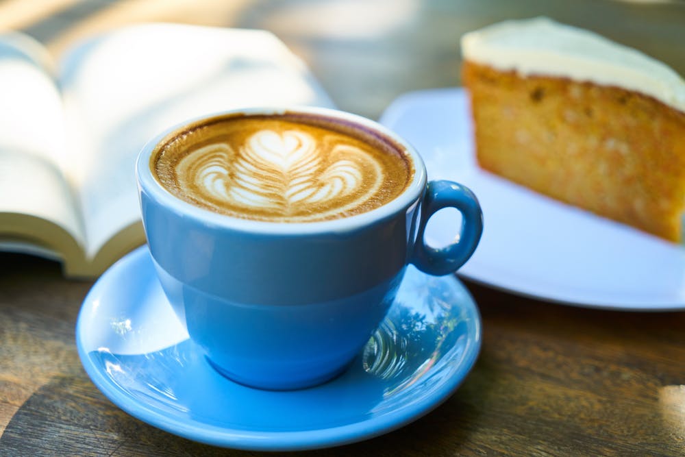 Blue cup and saucer with brown liquid