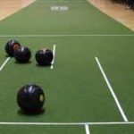 black bowls on a green mat