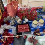 a red purse and artificial flowers