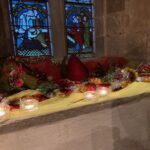 Christmas flowers and candles in the church