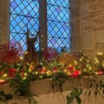 Christmas flowers and candles in the church