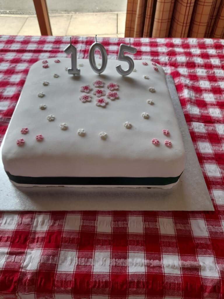 White cake with the number 105 on top