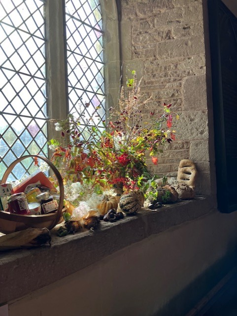 autumn flower display in church window