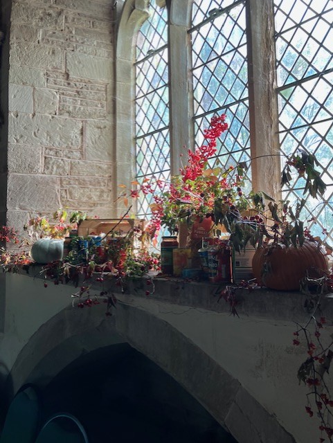 autumn flower display in church window