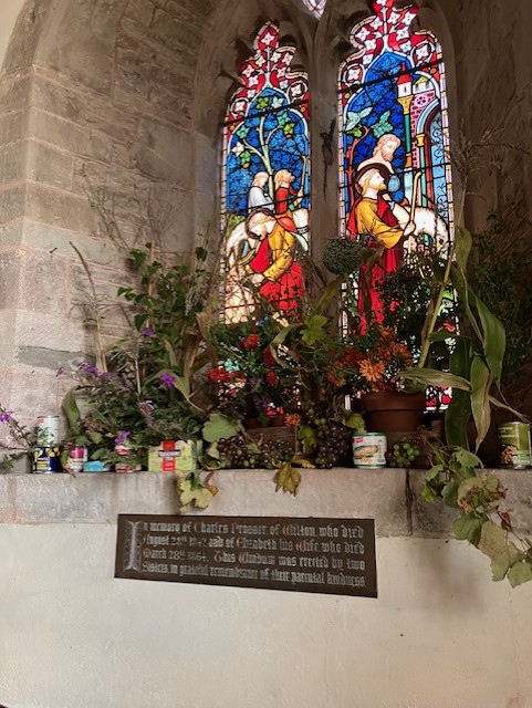 autumn flowers in front of stained glass window