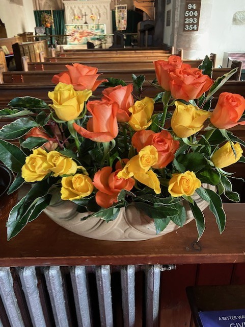 orange and yellow roses in a bowl