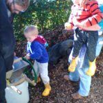 Boy in blue top using apple press