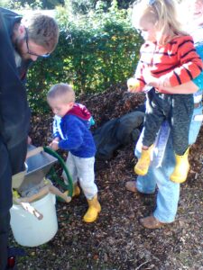 Boy in blue top using apple press